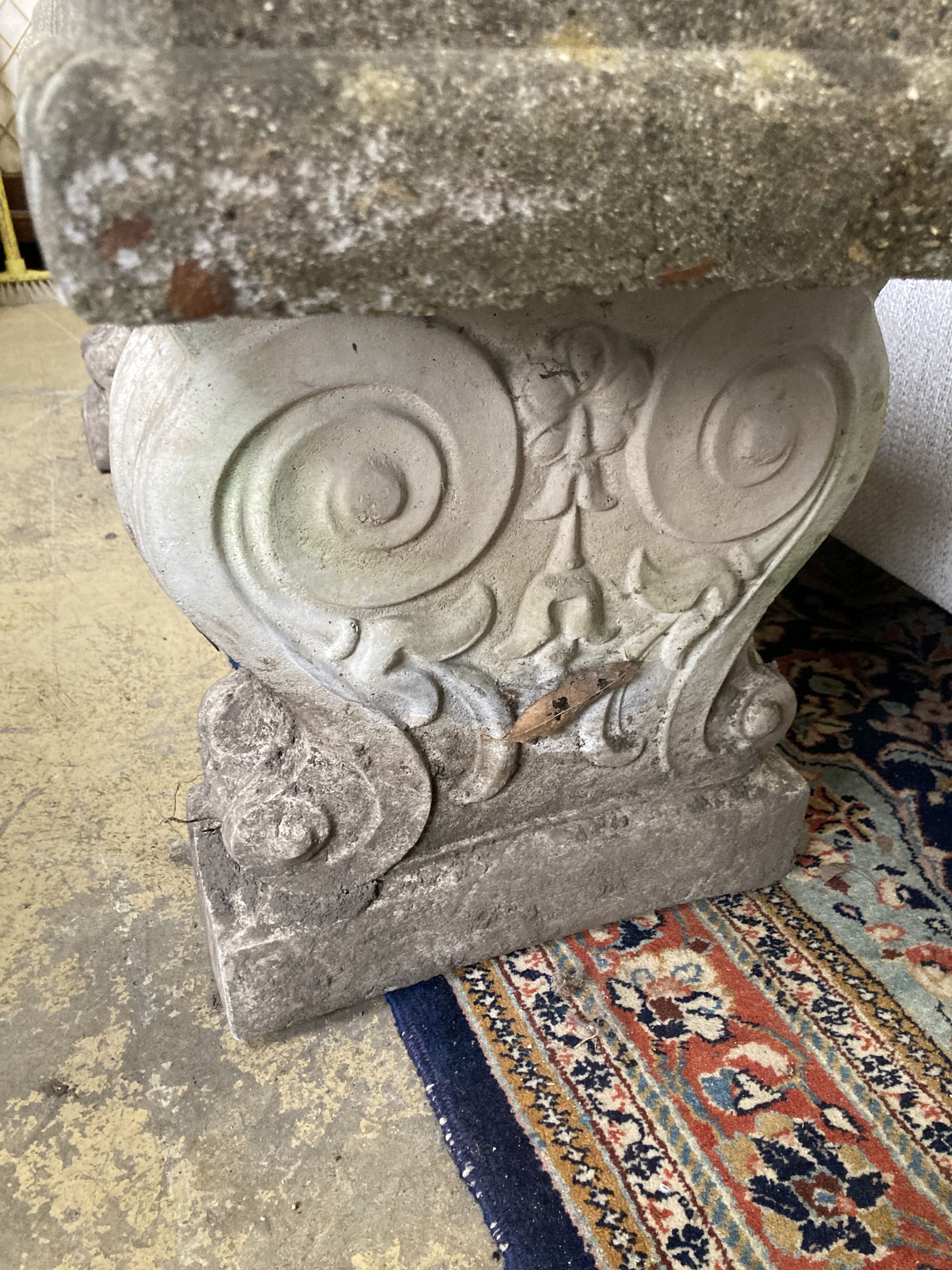 A reconstituted stone garden bench seat, length 126cm, depth 38cm, height 45cm